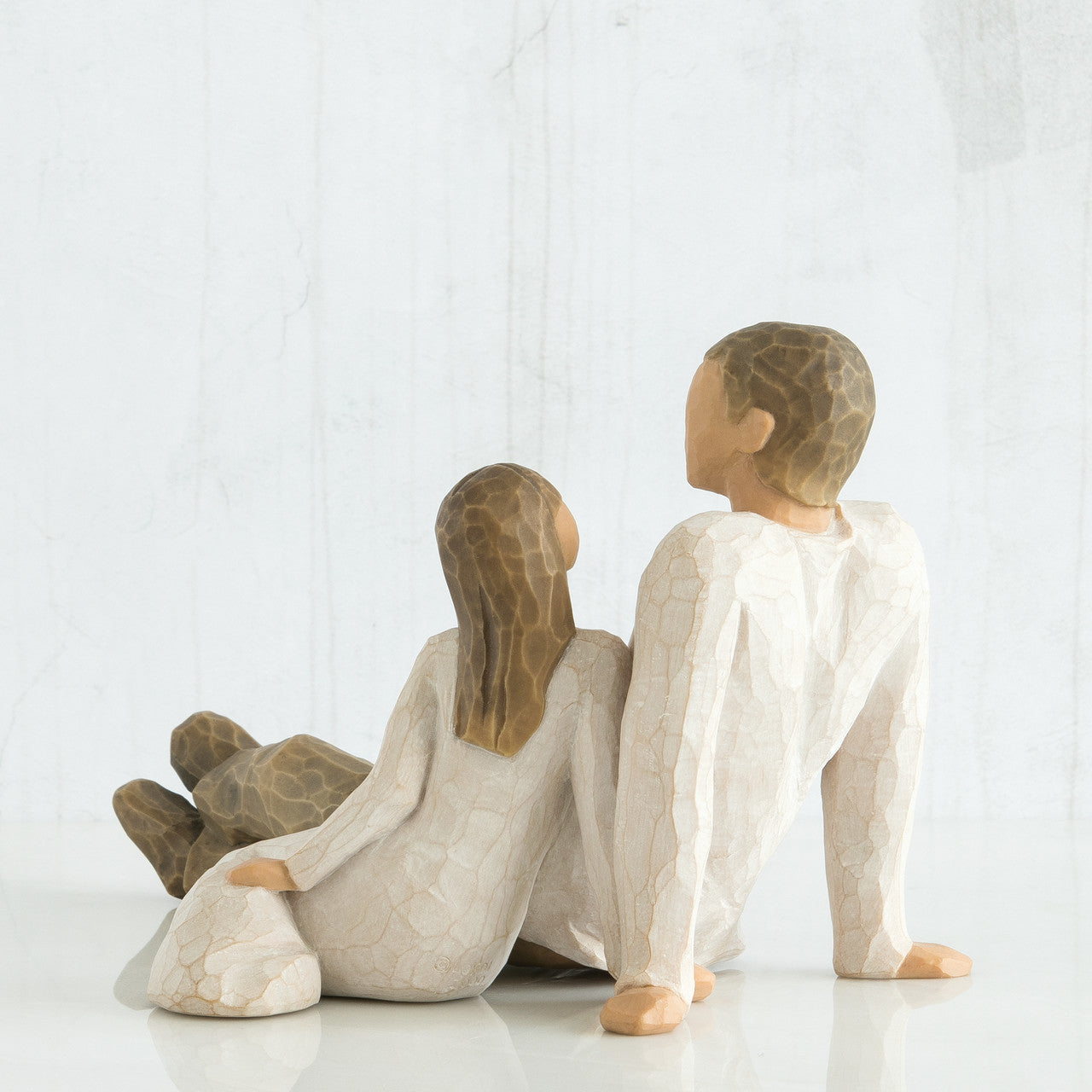 Willow Tree 'Father and Daughter' Figurine. This figurine depicts a father sitting with legs out infront of him, and his young daughter seated beside him, looking up to him.