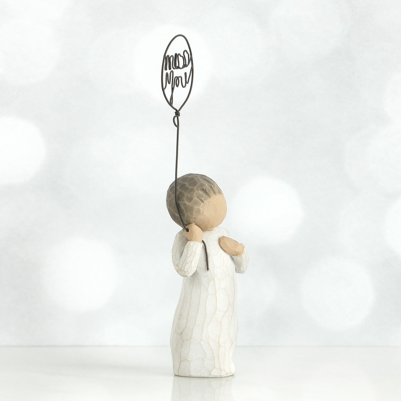 Willow Tree 'Miss You' Figurine. A figure holding a wire balloon with the words miss you within it.