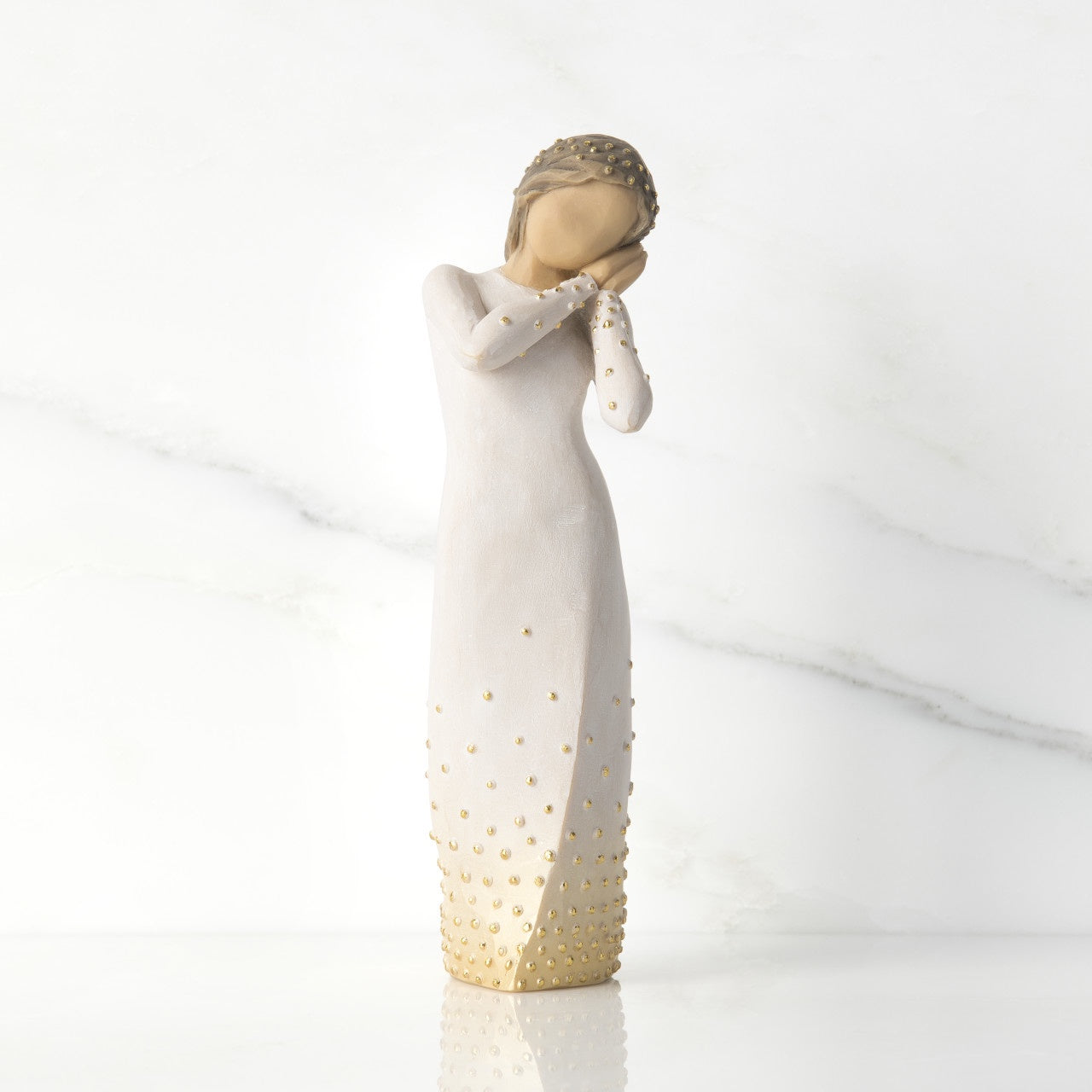 Willow Tree 'Wishing' Figurine. A female figure with tilted head resting on clasped hands, a hand-painted resin with applied gold leaf detail.