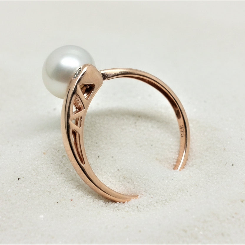 9ct rose gold asymmetrical ring featuring a white freshwater pearl and a small diamond.