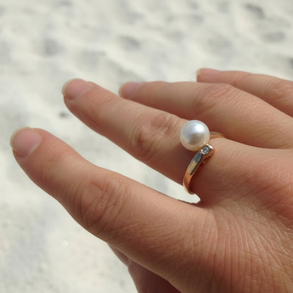 9ct rose gold asymmetrical ring featuring a white freshwater pearl and a small diamond.