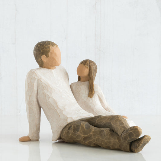 Willow Tree 'Father and Daughter' Figurine. This figurine depicts a father sitting with legs out infront of him, and his young daughter seated beside him, looking up to him.