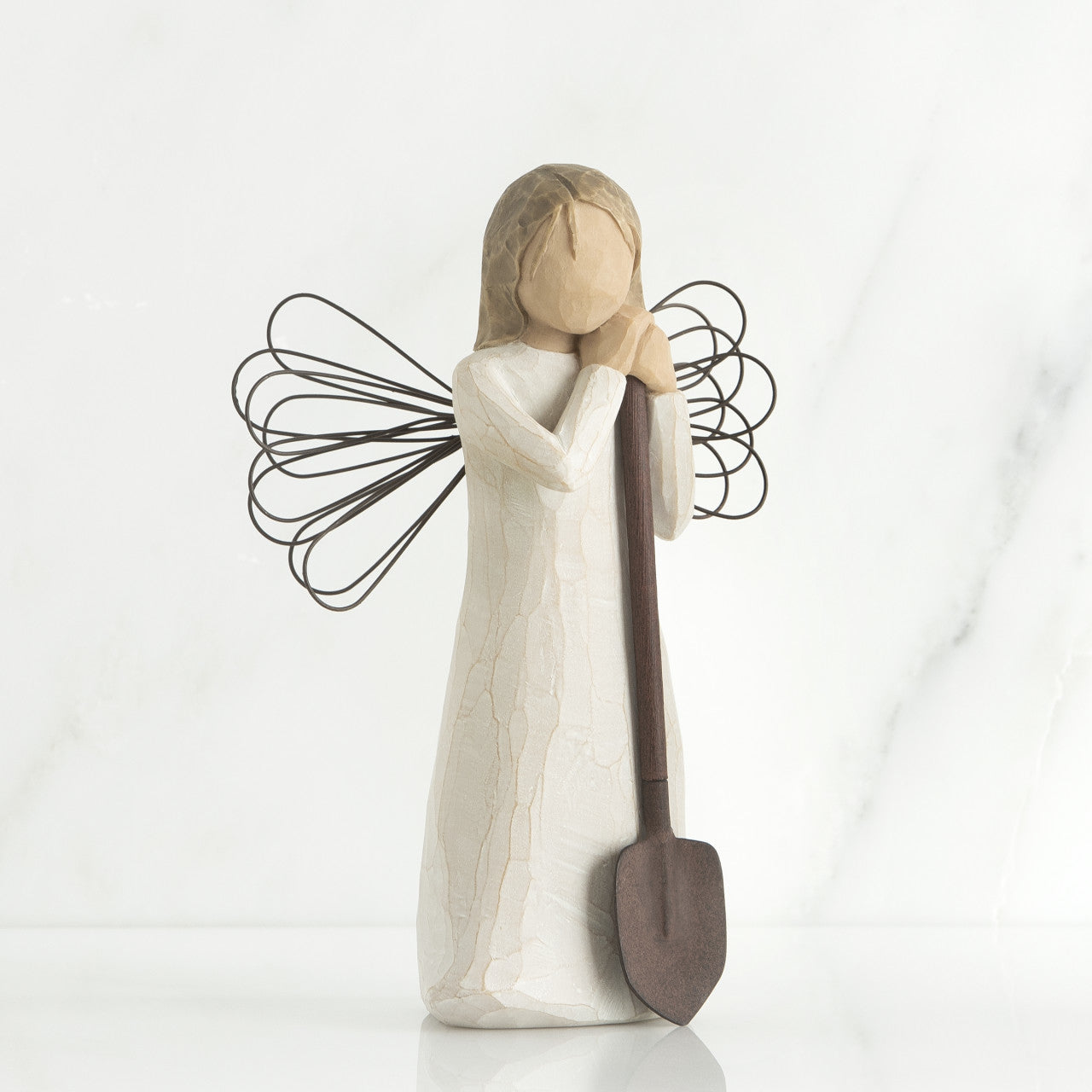 Willow Tree 'Angel of the Garden' Figurine depicts an angel figure holding a shovel as if leaving on it. Figurine Height Approx: 13cm.