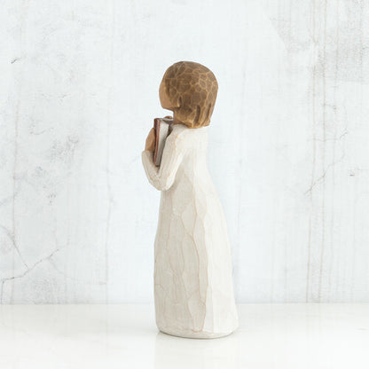 Willow Tree 'Love of Learning' Figurine. A young girl holding an open book close to her chest.