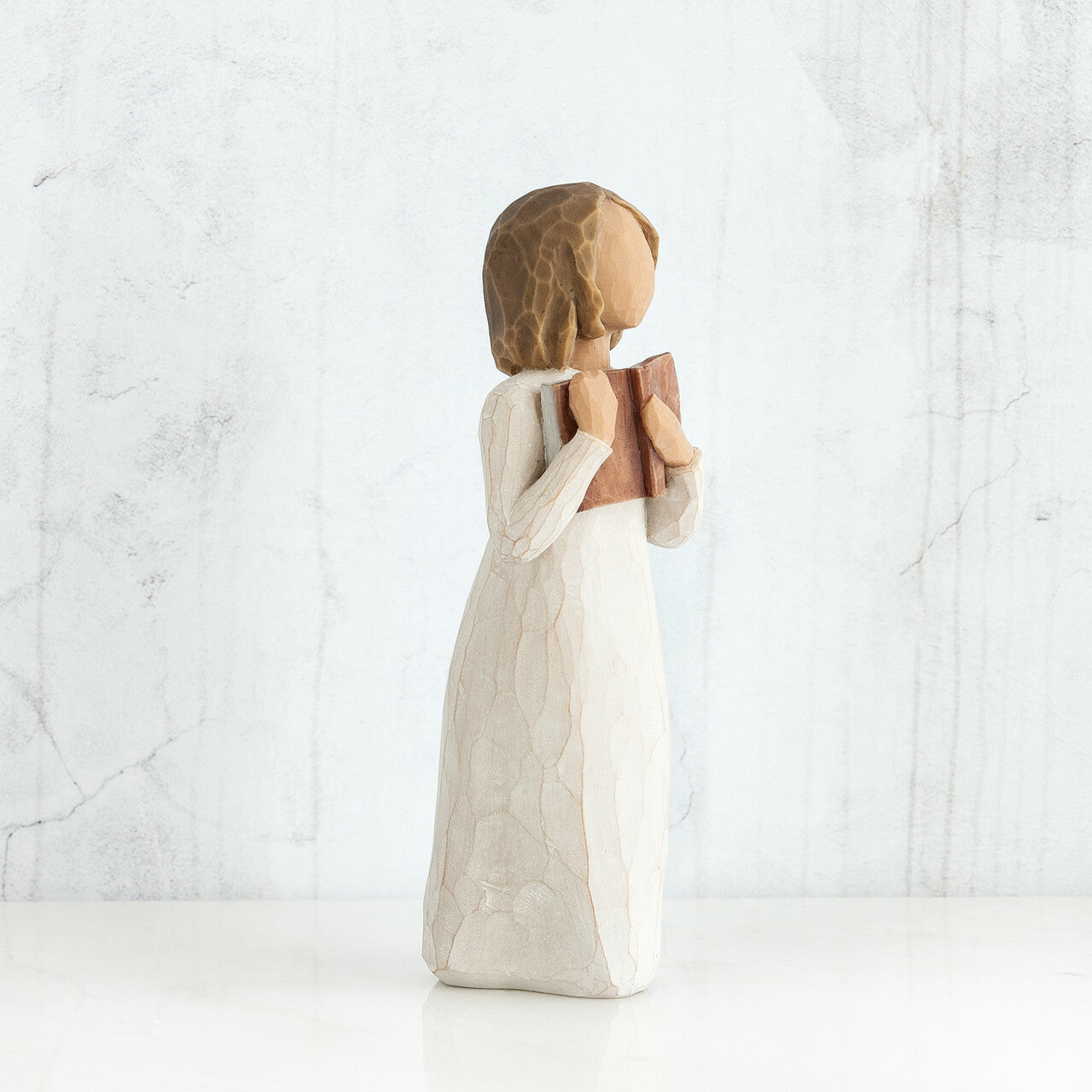 Willow Tree 'Love of Learning' Figurine. A young girl holding an open book close to her chest.