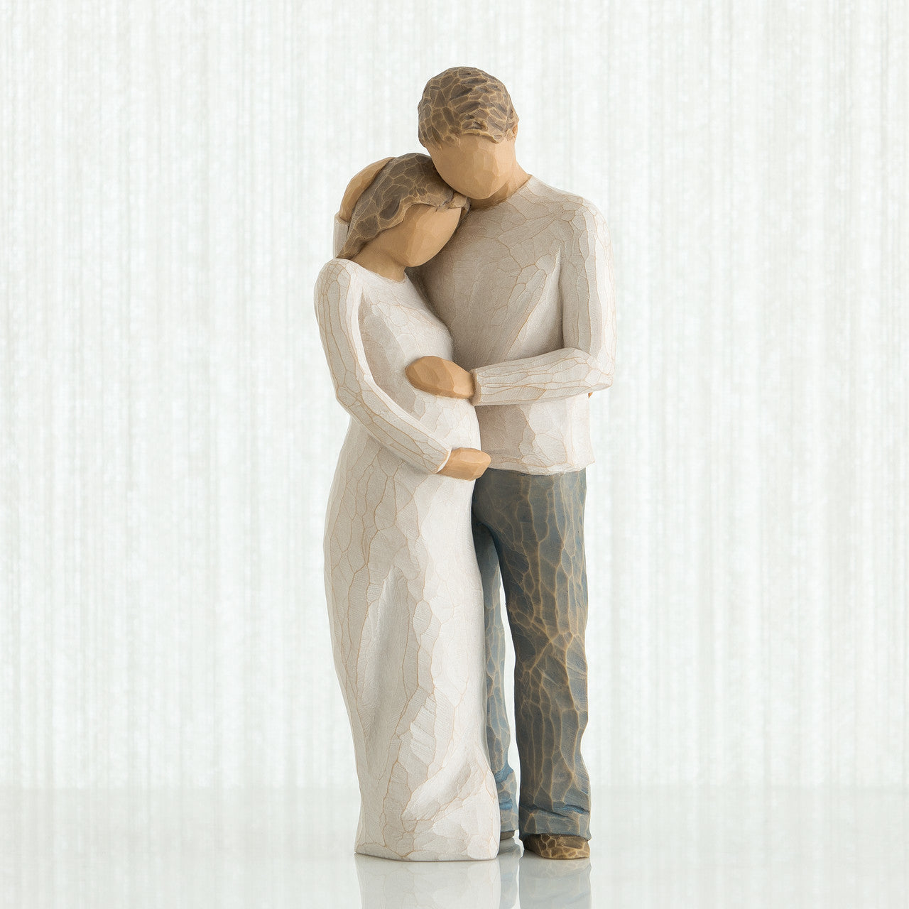 Willow Tree 'Home' Figurine. A figurine of a male and female couple in an embrace, with focus on the female figures pregnant belly.