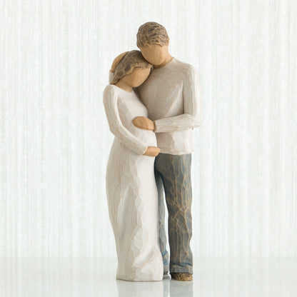 Willow Tree 'Home' Figurine. A figurine of a male and female couple in an embrace, with focus on the female figures pregnant belly.