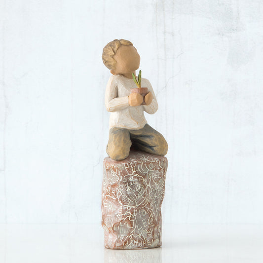 Willow Tree 'Something Special' Figurine. A young boy seated on a detailed stump holding a small potted plant.
