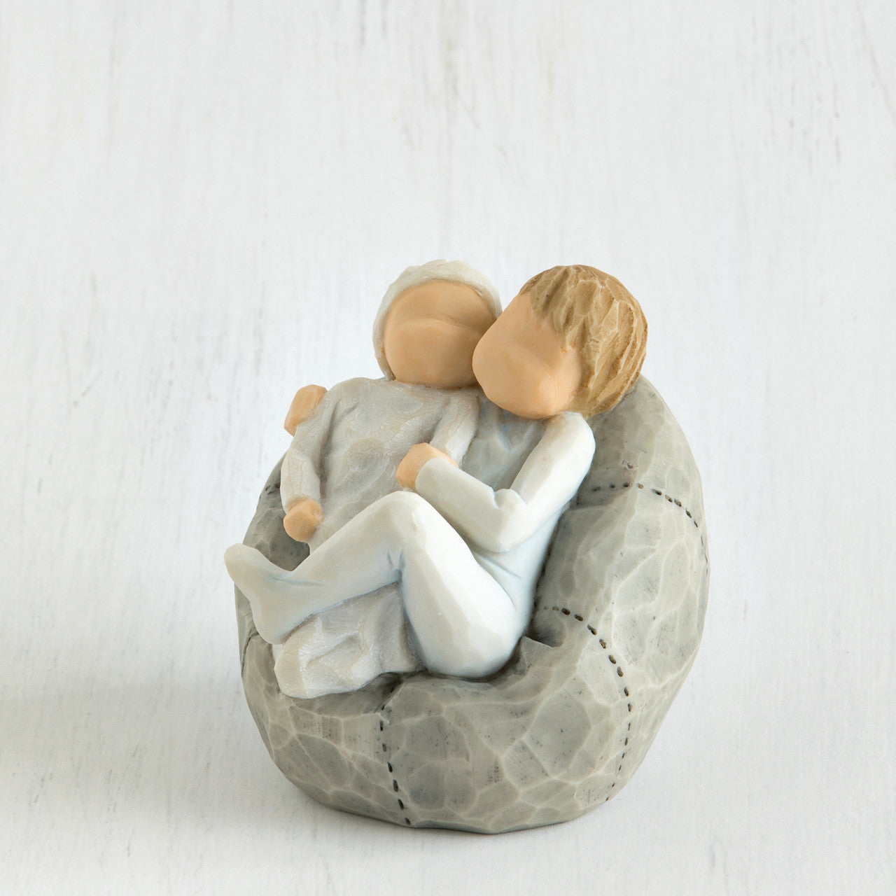 Willow Tree 'My new Baby' Figurine. Depicting a young child wearing blue holding a new baby also wearing blue.