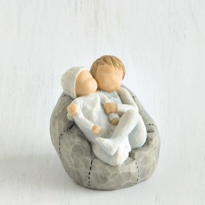 Willow Tree 'My new Baby' Figurine. Depicting a young child wearing blue holding a new baby also wearing blue.