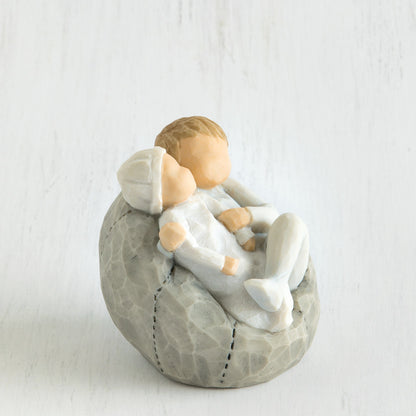 Willow Tree 'My new Baby' Figurine. Depicting a young child wearing blue holding a new baby also wearing blue.
