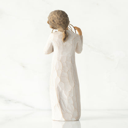 Willow Tree 'Love You' Figurine. A female figure holding a golden circle with love you written within.