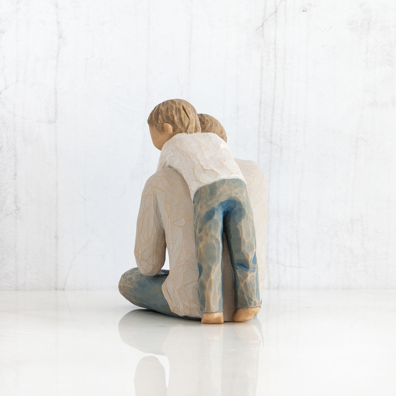 Willow Tree 'That's my Dad'. A Father seated with his young child behind him with arms wrapped around his neck.