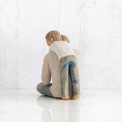 Willow Tree 'That's my Dad'. A Father seated with his young child behind him with arms wrapped around his neck.