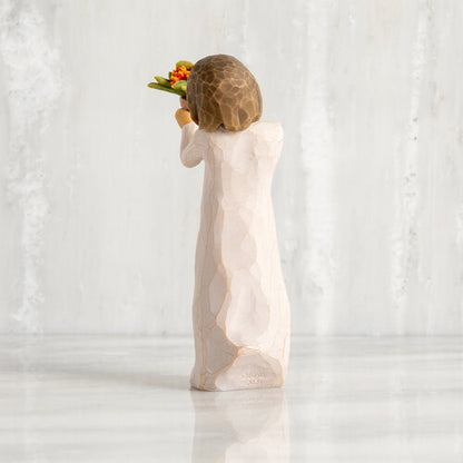 Willow Tree 'Little Things' Figurine. A young girl holding out a flower pot full of orange flowers.